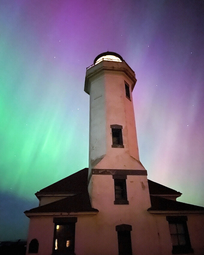 Point Wilson Lighthouse provides the foreground for the staggering light show, courtesy of the sun, that graced much of the country May 10. This image, taken by the lighthouse keeper, is among dozens of images of locals who shared photos of the Northern Lights phenomenon. Photo by Mel Carter    See story and images, A17 and A21.