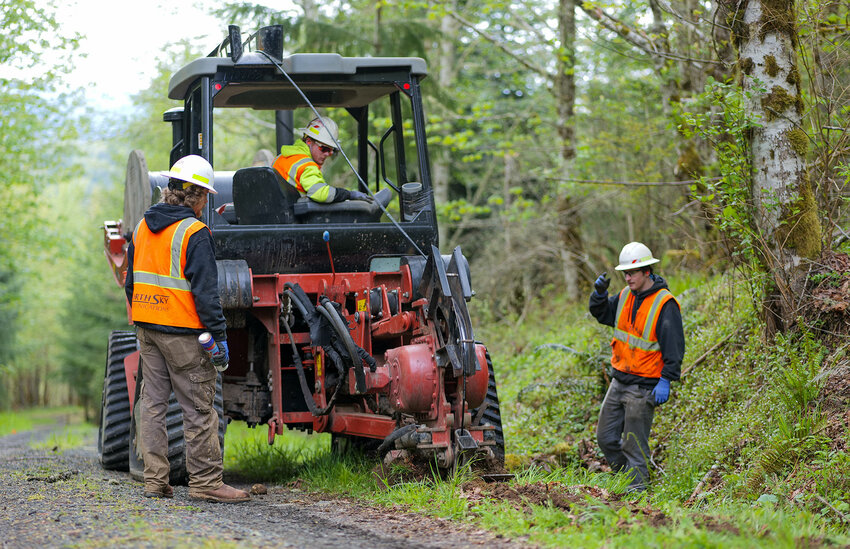 The Jefferson County Public Utility District&rsquo;s contract crew, North Sky Communications, runs underground fiber along Elkhorn Drive outside Quilcene.