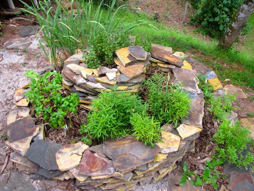 An herb spiral is a simple way to experiment with the idea of permaculture, using available materials and siting each plant to take advantage of water, sunlight, wind, and other natural elements.