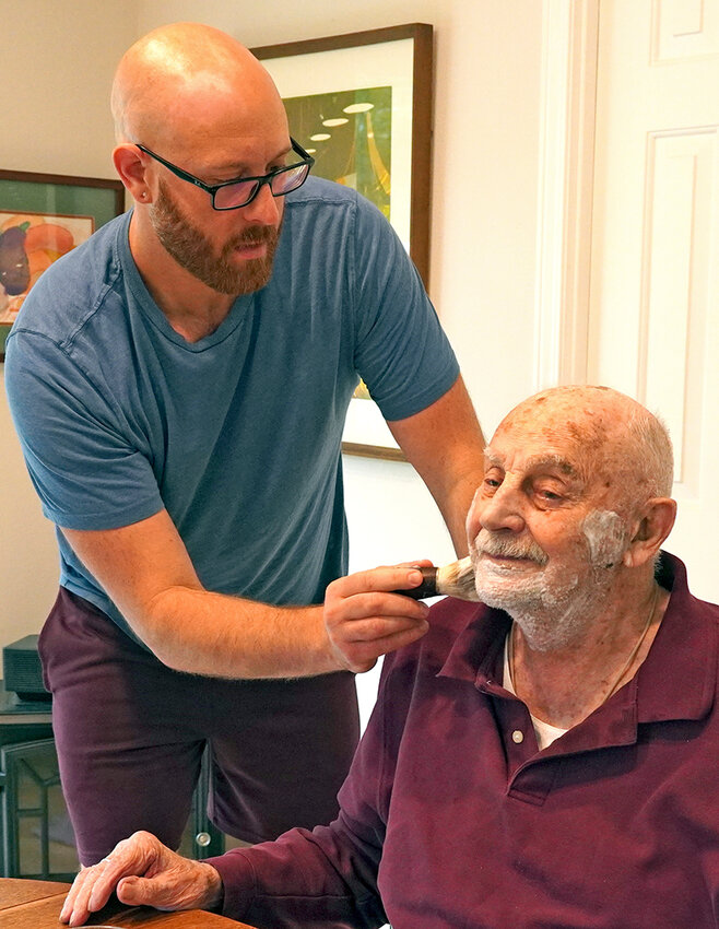 Robby, a caregiver-owner, gives Jim a fresh shave.