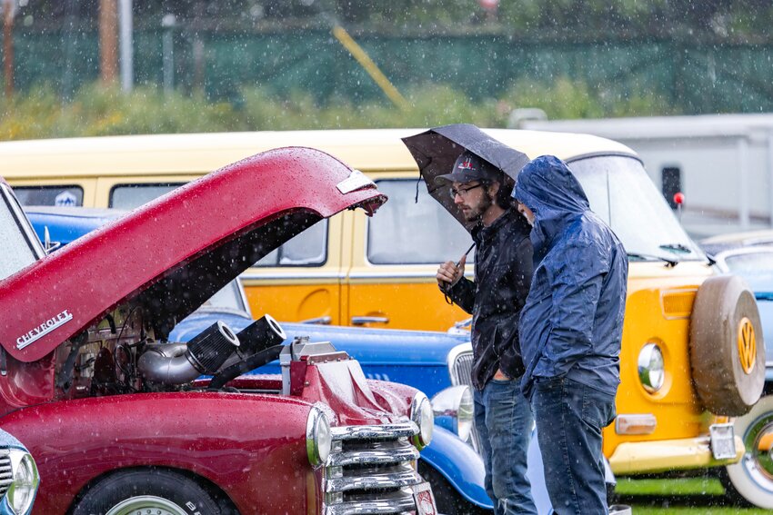 The Rakers Car Club hosted its annual car show on Saturday, June 15, at Memorial Field. Rain deterred some from bringing out their 1950s, 1960s and 1970s era vehicles, others stuck it out until the sun came out. Kyle Roth and Eli Chiprout check under the hood during the annual Raker’s auto show at Memorial Field in downtown Port Townsend on Saturday, June 15.