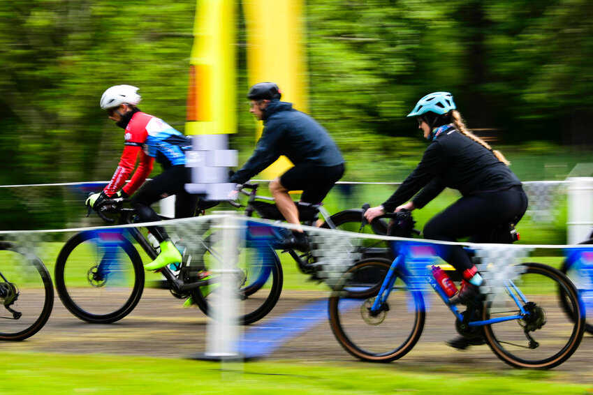 Cyclists spin through Quilcene headed for the Olympics on a rainy Saturday, June 15.