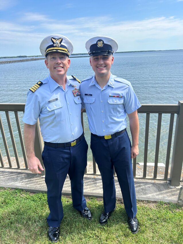 U.S. Coast Guard Capt. Brian Erickson and Intelligence Specialist 3rd Class Isaac Reid share a moment of camaraderie at the Commanding Officer&rsquo;s Quarters at U.S. Coast Guard Training Center Yorktown in Virginia on Friday, June 7, following Reid&rsquo;s promotion and graduation.