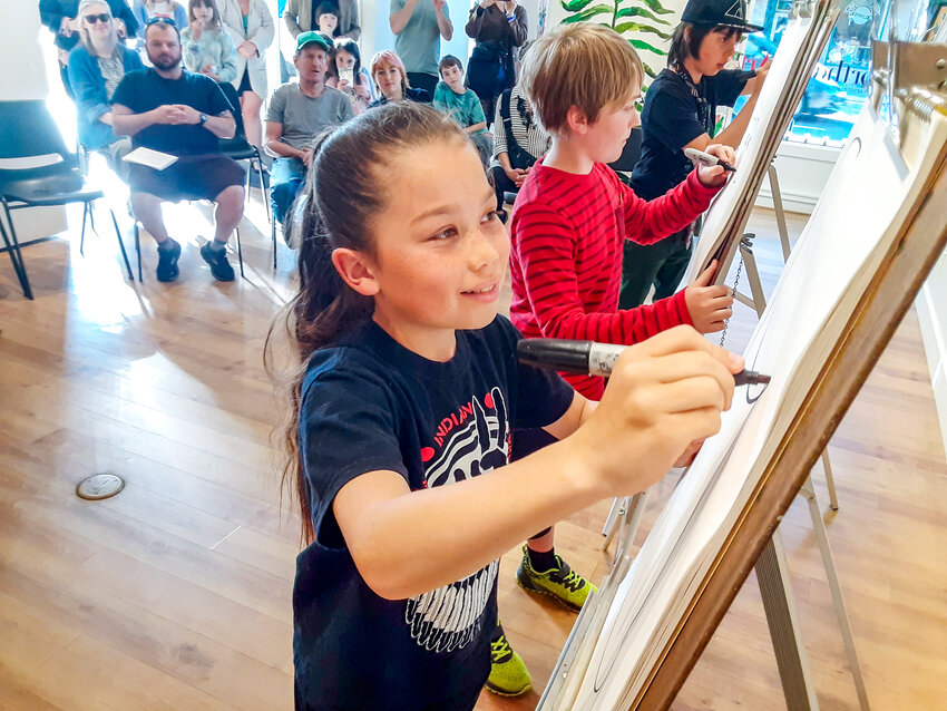St̓ša Ellis-Hall, seen here drawing for an audience at Northwind Art, plans to follow up working on a zine with a more ambitious, mural-style art project.
