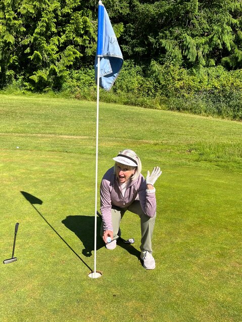Dee Sweeney celebrates her first hole-in-one on the par three #3 hole at Discovery Bay Golf Club.