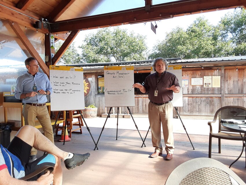 George Terry and Joel Peterson, long-range planners for Jefferson County, explain the nuances of the impending comprehensive plan update to members of the East Jefferson Trails Connection at the Finnriver Farm and Cidery on July 11.