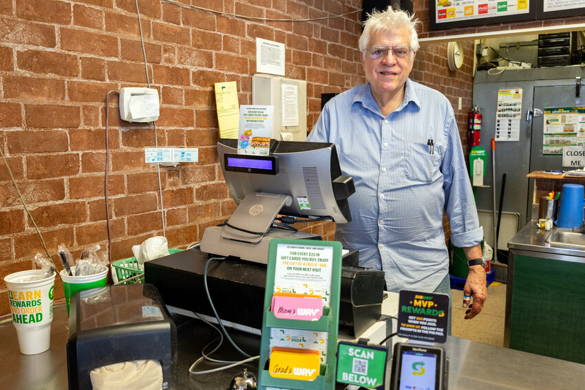 Mick Davis bids farewell to the checkout of the Port Townsend Subway shop, where he personally rang up a number of customers&rsquo; orders over the years.