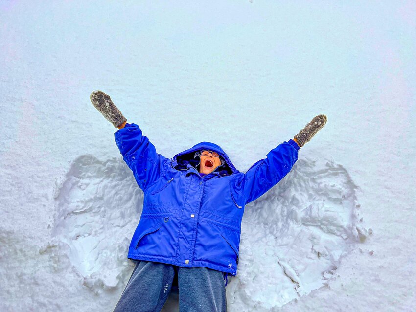 “Mrs. A,” a 92-year-old resident of a live-in health care center, joyfully makes a snow angel.