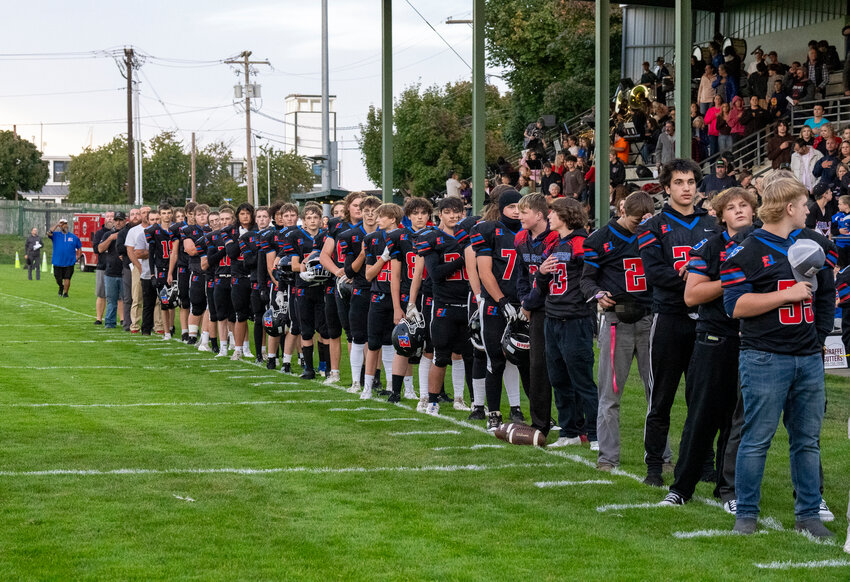 The East Jefferson Rivals stand tall during the National Anthem before a Friday Sept. 20, game against the Cougars of Cascade Christian played at Memorial Field in Port Townsend.