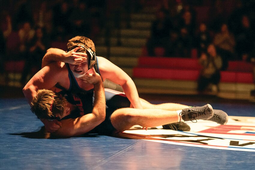 Mason Iverson, a senior, has Life Christian Academy wrestler Zachary McNight on his back. Mason kept McNight — the 8th ranked wrestler in the state —  in this position to win by pin in his last home wrestling event.
