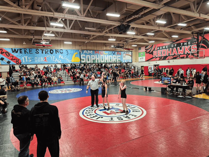 Angie Luckhurst, a Chimacum sixth grader, has her hand raised after defeating Marco Arabella of Sequim on March 12 at Port Townsend High School.