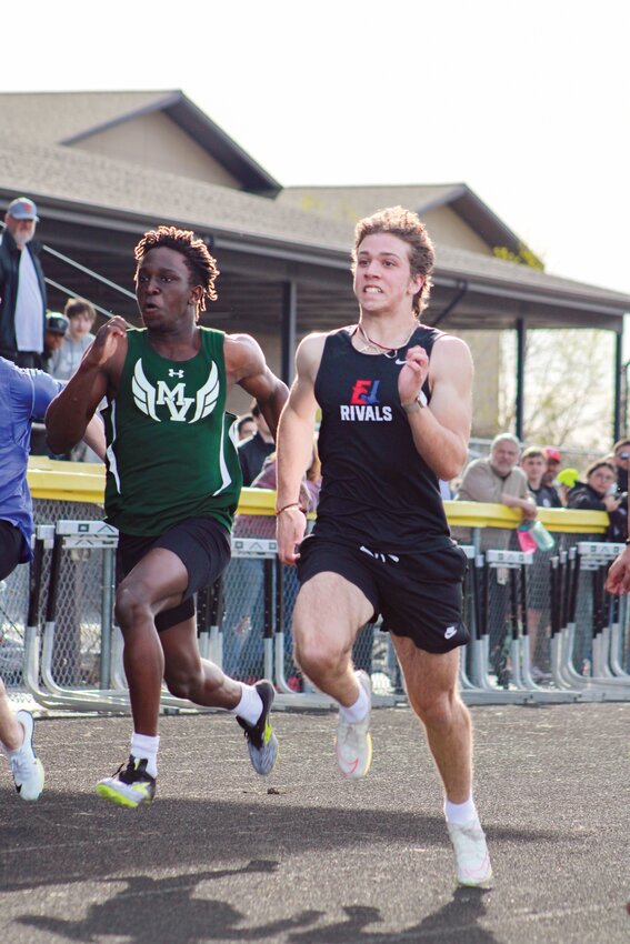 Senior Nikolas Erickson pushes hard in the 100m.
