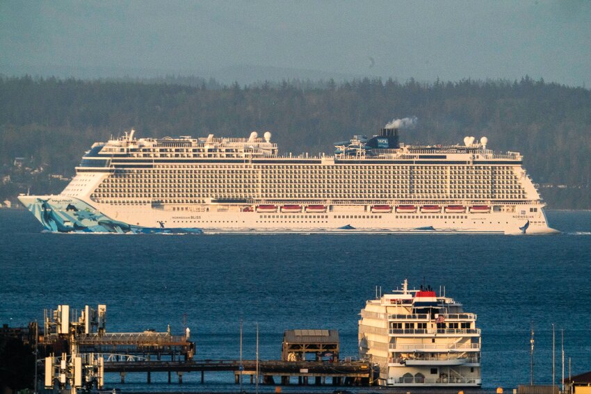 Summer cruise&nbsp;season begins with Norwegian Cruise Lines 4,000-passenger Norwegian Bliss passing by Port Townsend on Saturday, April 12, enroute to Alaska. The more demure Constellation, operated by American Cruise Lines, takes it in from the downtown dock.