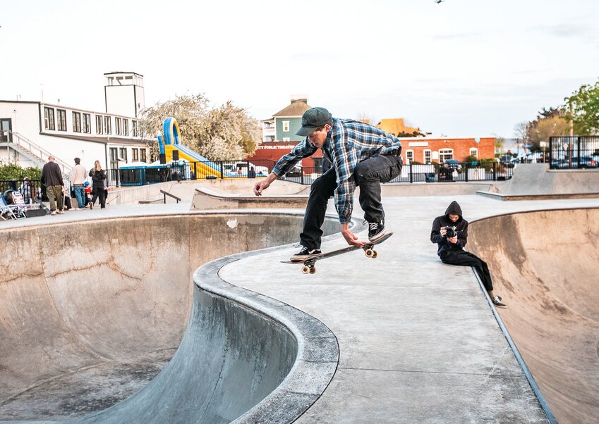 Kai Dakers, from Quilcene, performs an Indy Air while jumping from one bowl to another during a Saturday, April 19, open house and dedication of the new solar lights at the Seamus Sims Skate Park. For the full story, see page A26.