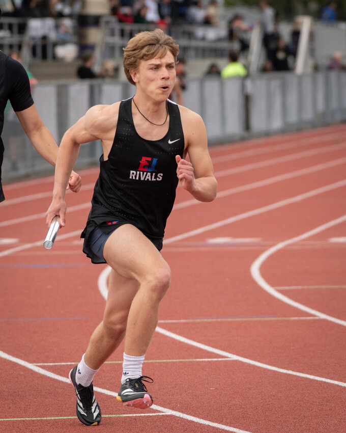 Zeke Banks get the baton to run his best 4x400 relay split of the year.