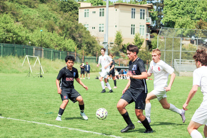 Crosby and Alan vs Seattle Christian: Port Townsend High School sophomore Crosby Pray advances the ball while his teammate, Alan Morales, prepares to assist.