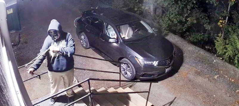 Security footage shows Woods wearing a black face covering and using a wrist rocket sling shot to break into a building.