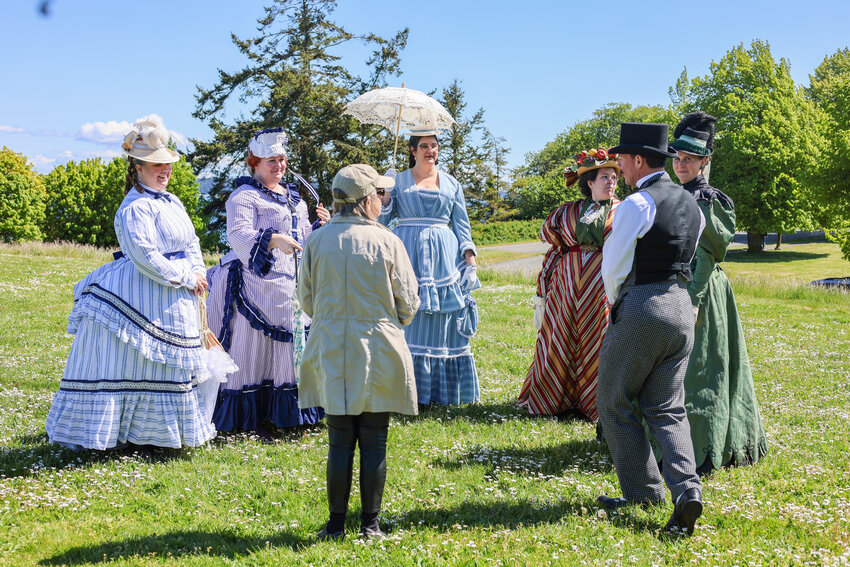 Besty Hanson, a Seattle resident in town for Centrum’s Ukulele Festival, chatting with a group of participants in this year’s Port Townsend Victorian Heritage Festival on May 5. The weekend was filled with events, from afternoon tea at historic homes and a fashion show to a tour of the post office and a stroll around Fort Worden. 