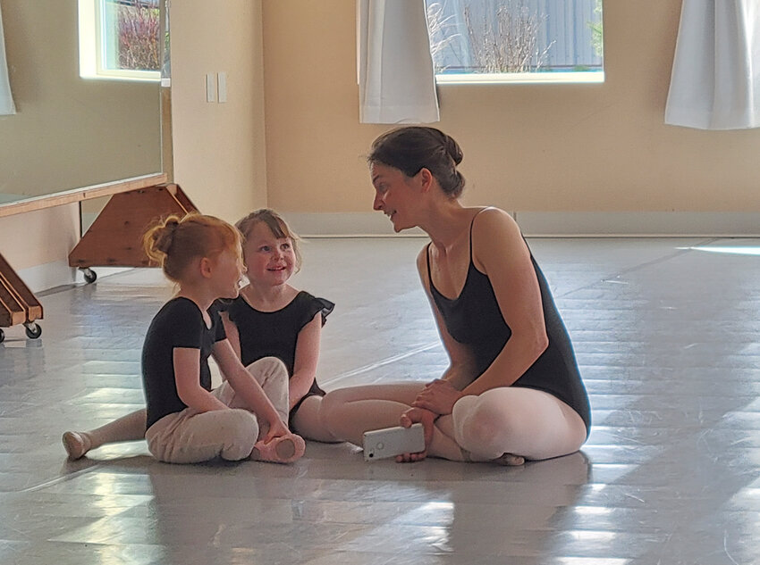 Miss Lauren talks with pre-ballet students. She teaches all levels of ballet. Port Townsend Ballet Artistic Director uses some down time to take in a tutu during a rehearsal, below.