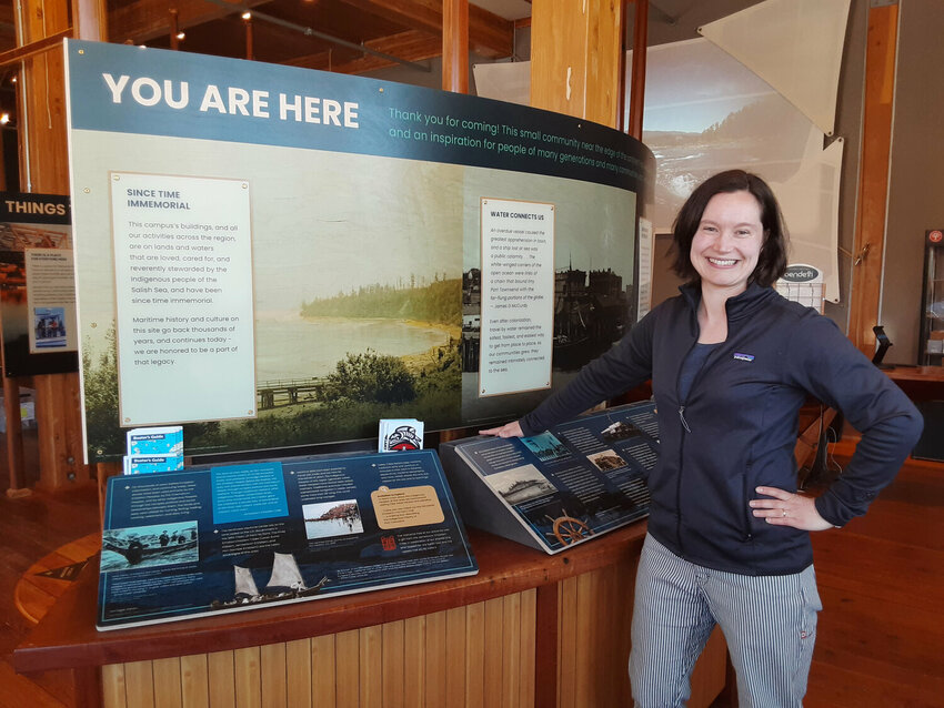 Northwest Maritime Center Campus Director Kate Philbrick shows off the Welcome Center&rsquo;s &ldquo;You Are Here&rdquo; informational display.