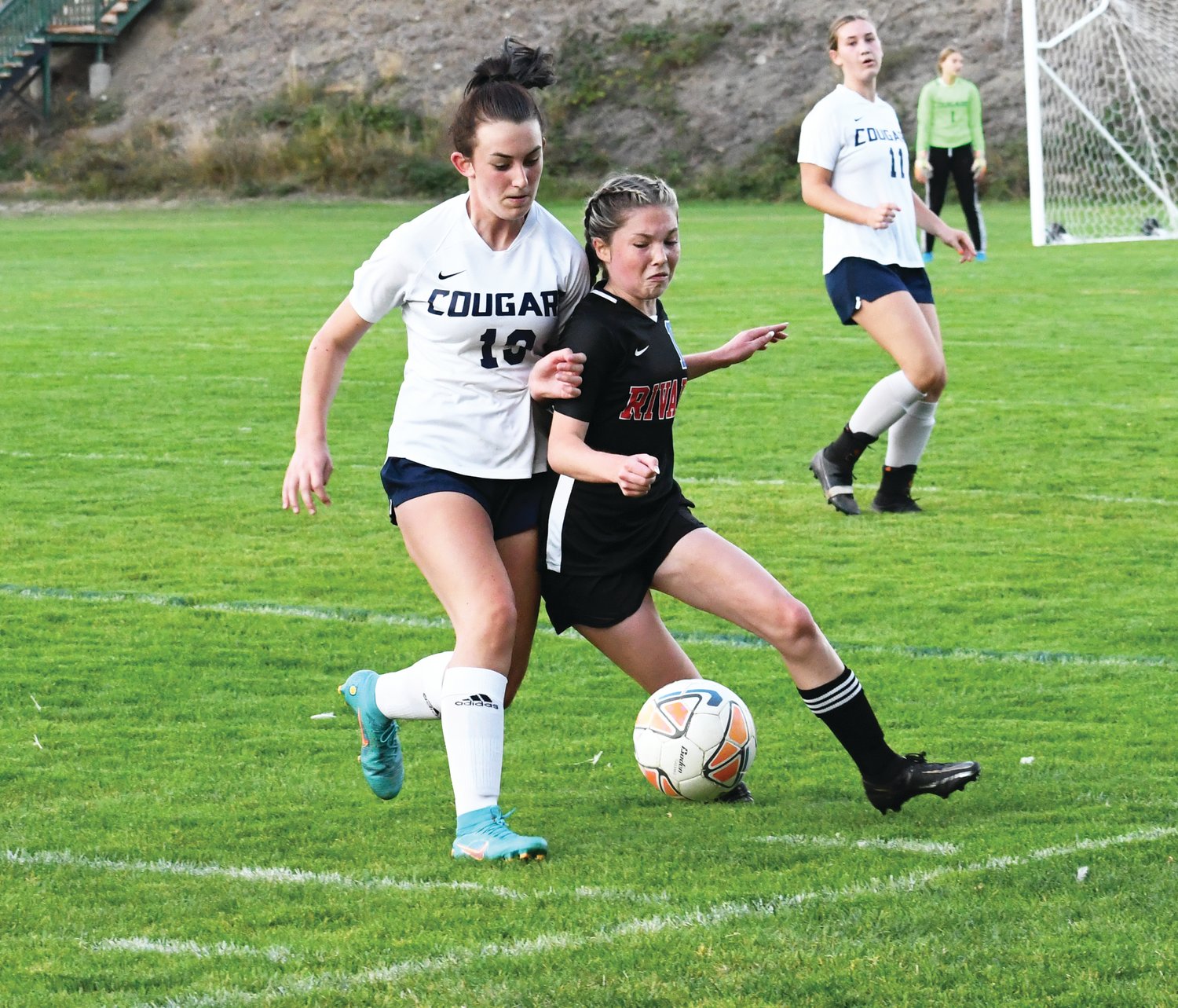 EJ junior and attacking midfielder Ava Shiflett battles a Cascade Christian player for possession. Shiflett scored a goal in the Tuesday home matchup.