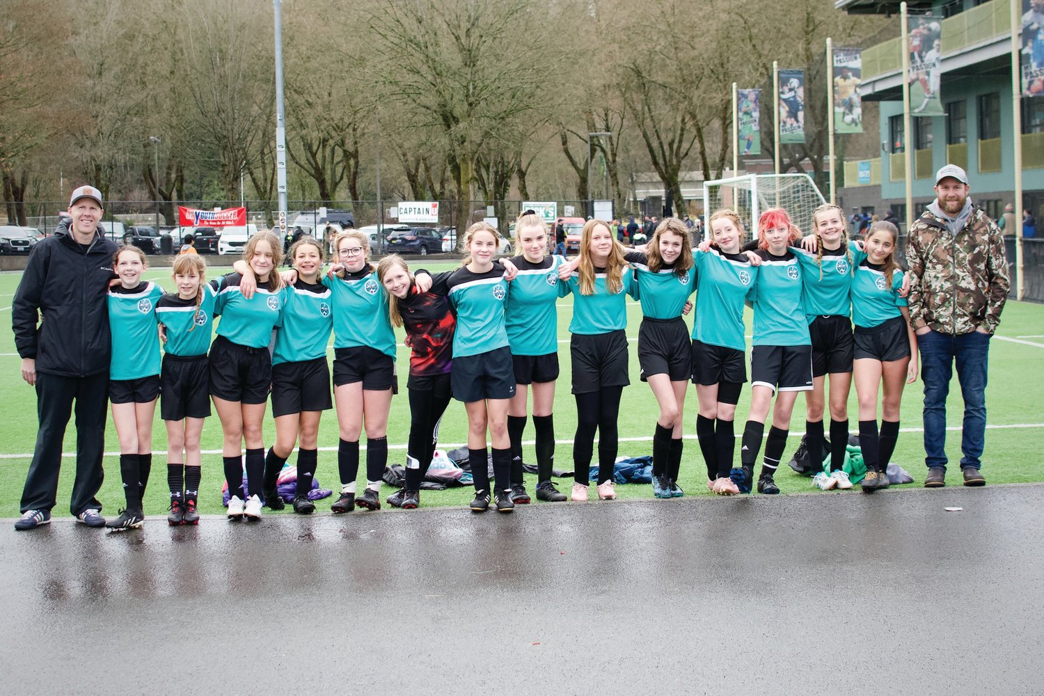 The U-14 Bobcats squad and coaches Simon Little and Josh Brown pose during the state championship in Tukwila. Jim Emory photo