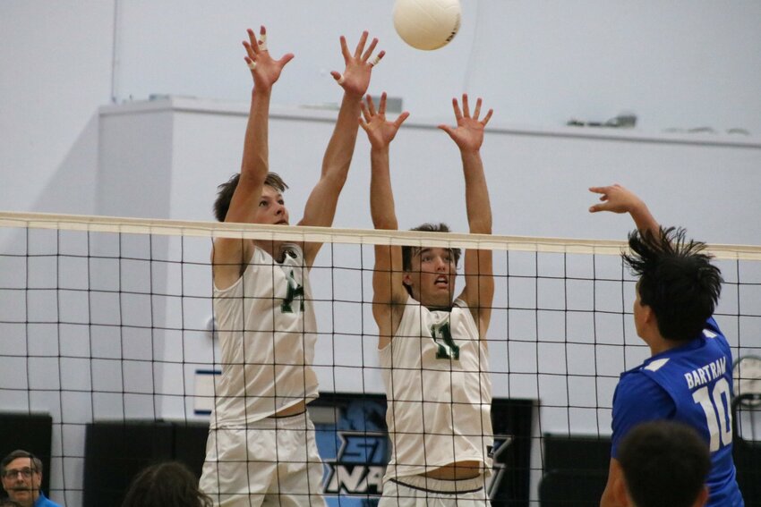 Jameson Haughey and Dennis Rehm combine to block a shot.