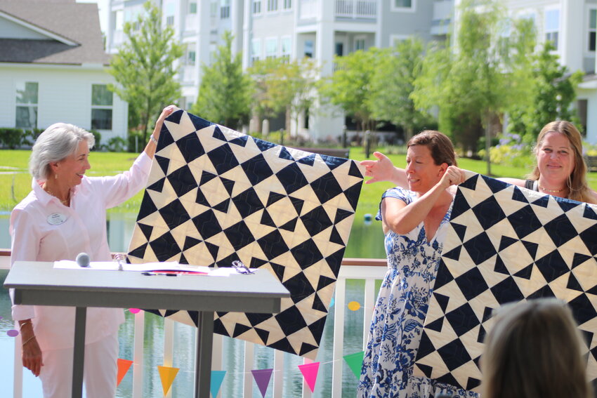 A quilt that students worked on was presented to Vicar’s Landing at Oak Bridge during the ceremony by representation from the Jacksonville Modern Quilt Guild.