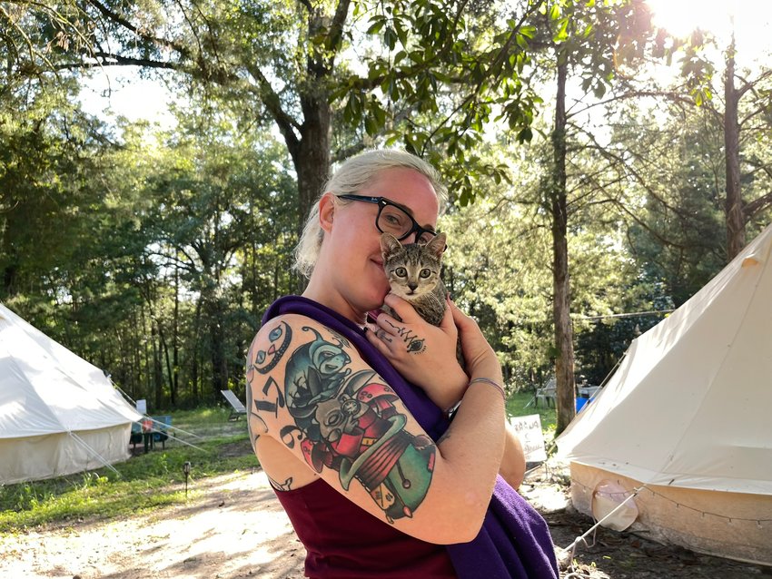 A woman cuddles one of the feline residents of Purradise Springs.