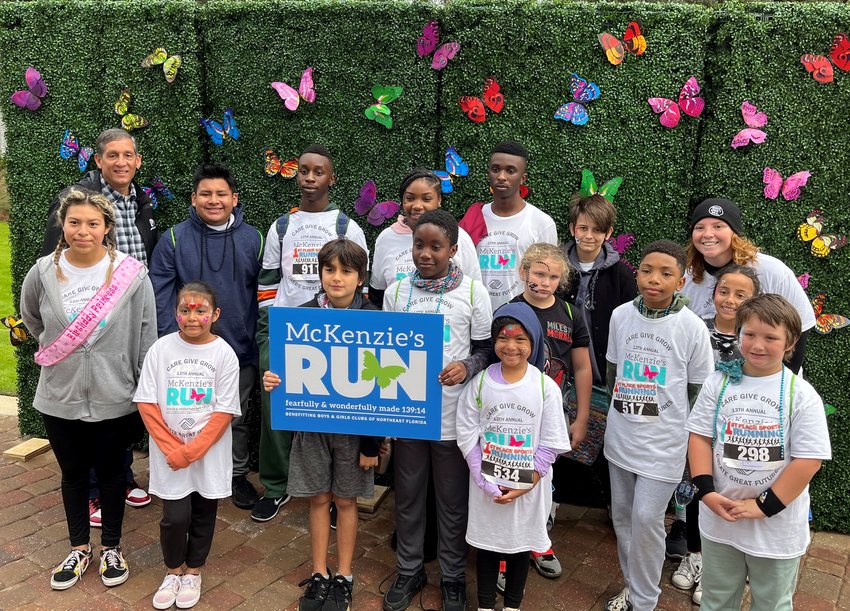 Boys &amp; Girls Clubs of Northeast Florida President &amp; CEO Paul Martinez poses with club members from McKenzie&rsquo;s Beaches Boys &amp; Girls Club after they completed the 5K at the 13th Annual McKenzie&rsquo;s Run.