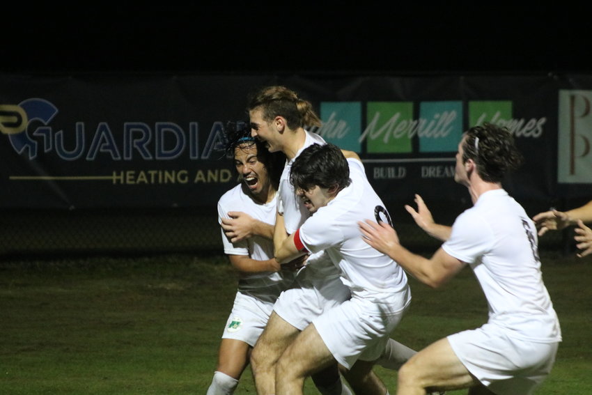 Nease&rsquo;s Tyler Ghazanfari (middle) is swarmed by teammates after scoring the game-tying goal in the 73rd minute against Ponte Vedra on Dec. 7.