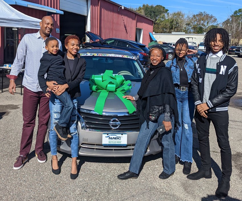 Laniya Flowers, center-left, surrounded by family, receives a Nissan Altima in recognition of her status as 2022 Youth of the Year for Boys &amp; Girls Clubs of Northeast Florida.