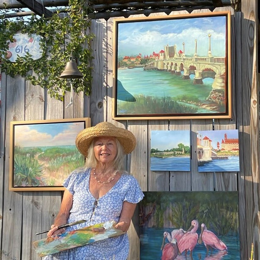 Artist Pamela Geiger is seen surrounded by some of her work.