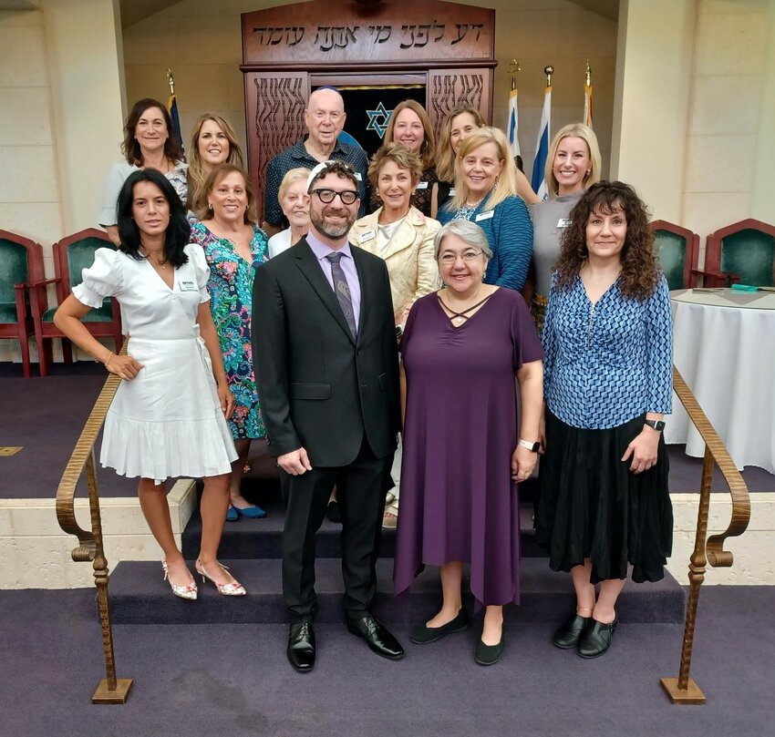 Members of Beth El the Beaches Synagogue installation committee and board gather on the bimah prior to the installation of Rabbi Benjamin Dyme, standing at center.