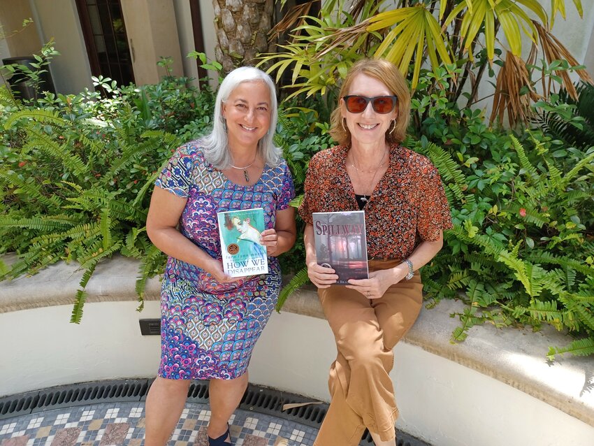 Tara Lynn Masih, left, holds up her short story collection, &ldquo;How We Disappear,&rdquo; and Kim Bradley holds up her collection, &ldquo;Spillway.&rdquo;