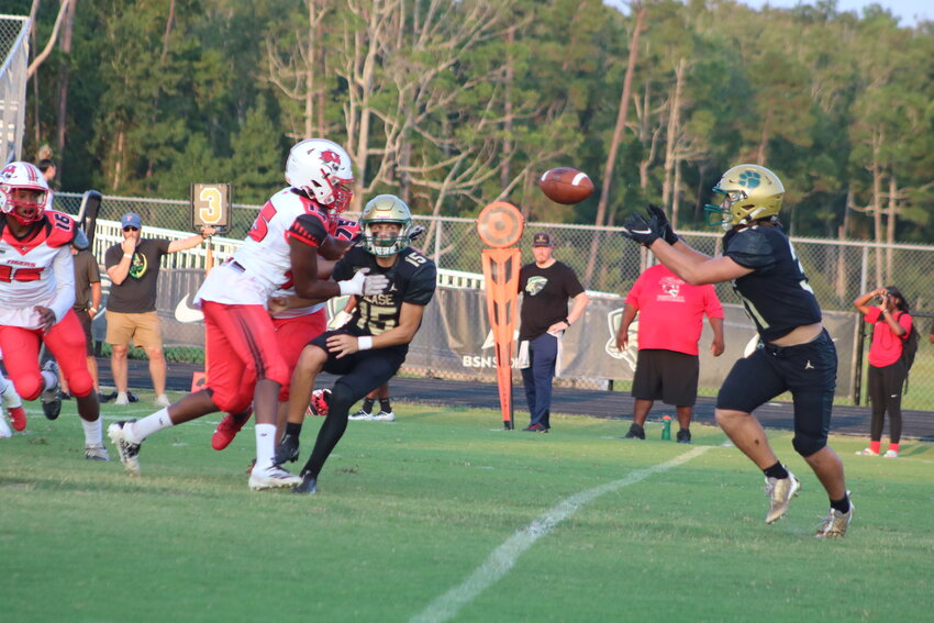 Sophomore Quinn Bradfield receives an option pitch from quarterback Nate Harry (No. 15).