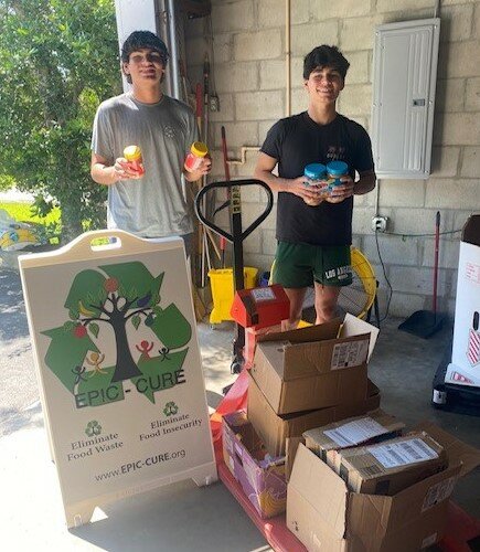 Kelland, left, and Connor Franco are seen with donations from the previous Peanut Butter Drive, held over the summer.