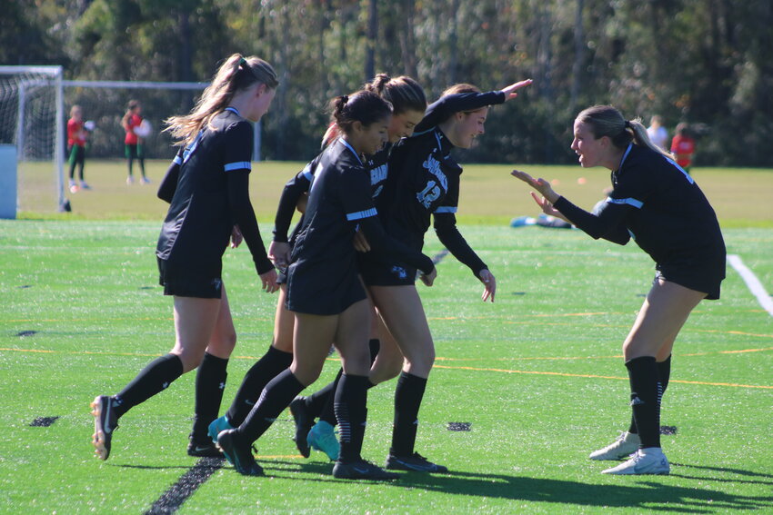 The Sharks celebrate their game-winning goal against Monteverde Academy on Jan. 20.