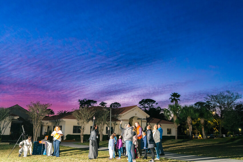 Bolles Lower School Ponte Vedra Beach Campus first graders and their families gaze into the night sky.