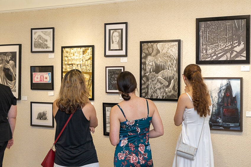 Students look at work during the 2023 St. Johns All-County High School Art Show.