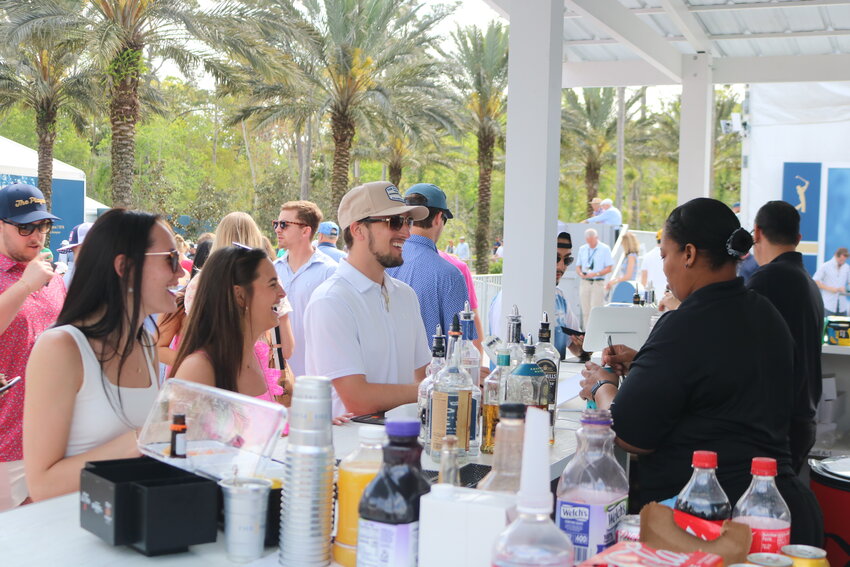 Fans order drinks at the bar during the third round.