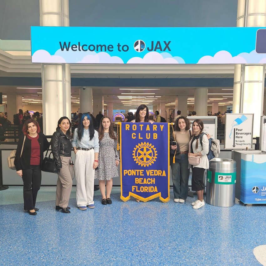 Rotary Club of Ponte Vedra Beach President Jennifer Logue welcomes the Armenian delegation at Jacksonville International Airport.