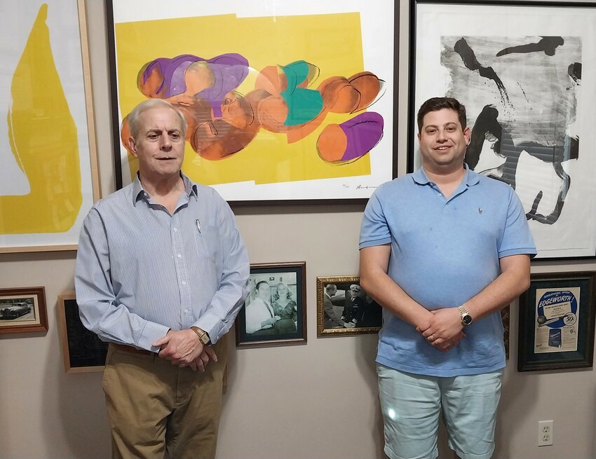 John and Alex Graves are surrounded by some of the artworks they collect and sell.