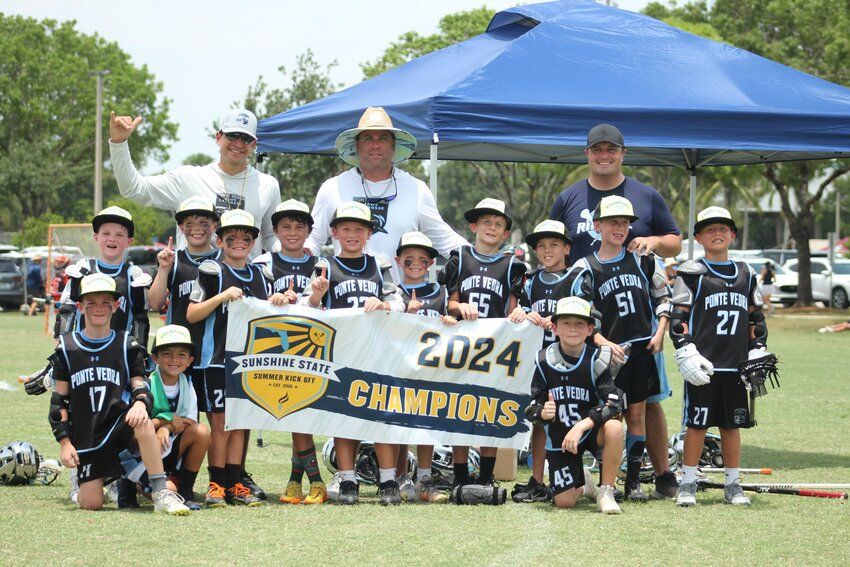 The 8U Jaws Black Tip team with the Championship Banner.