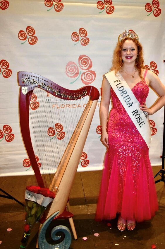 Newly crowned Florida Rose of Tralee Molly Ronan stands next to her harp.