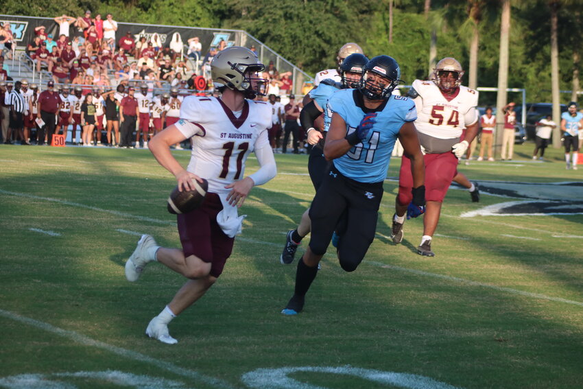 St. Augustine quarterback Locklan Hewlett rolls out and is chased by Ponte Vedra&rsquo;s Ryker Kemp.