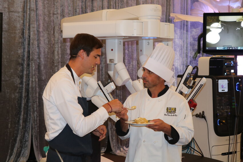 Featured chef Colin McClimans and Dr. Martin Martino of Ascension St. Vincent&rsquo;s teamed up with a surgical robot to make complete the dessert dish at the 22nd Annual Delicious Destinations.