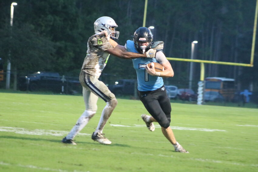 Brain Case fights for yards against a defender.