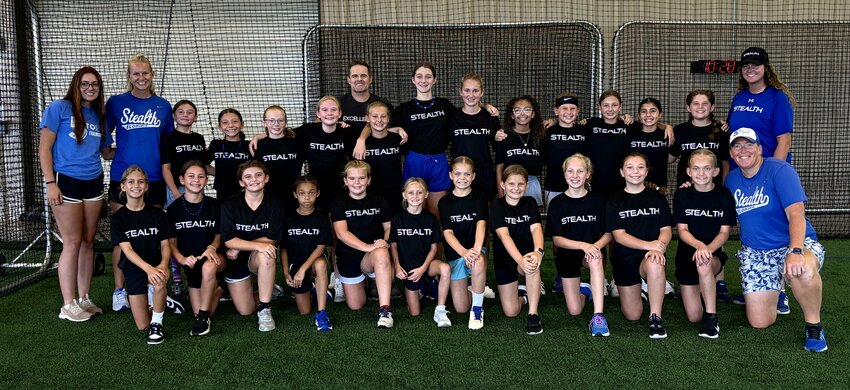 The 10u and 12u teams pose with author Allistair McCaw at the Florida Stealth softball kickoff.