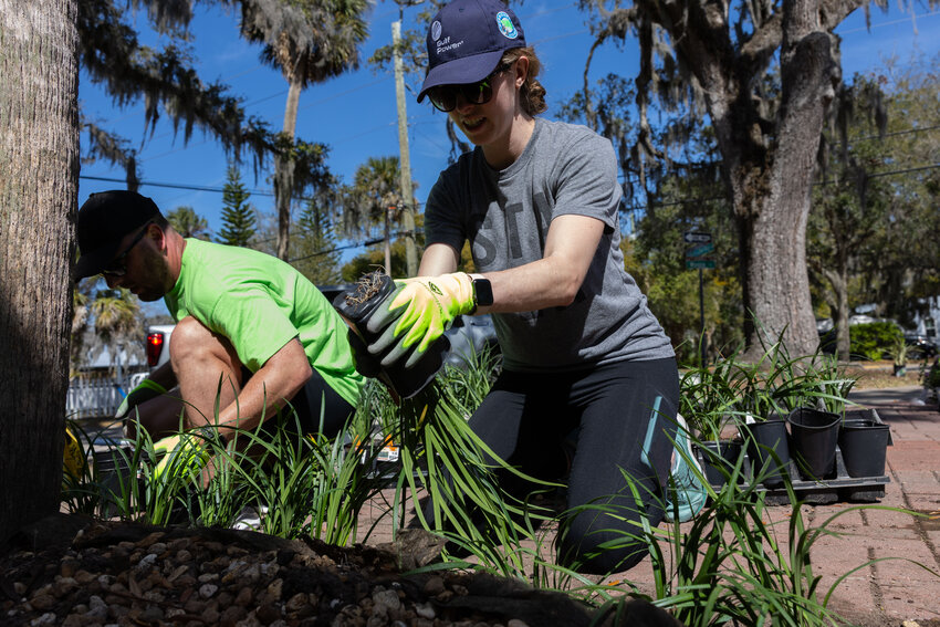 FPL volunteers Josh Keown, left, and Alyssa Fink help beautify flower beds to spruce up the Lincolnville Museum and Cultural Center in St. Augustine as part of the company&rsquo;s annual Power to Care Week.